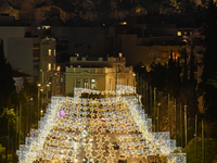 Christmas lights decorate a main street with the Acropolis in the background in Athens, Greece, on December 18, 2024. (