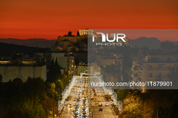 Christmas lights decorate a main street with the Acropolis in the background in Athens, Greece, on December 18, 2024. 