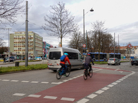 Cyclists, cars, and a bus are at an intersection in Munich, Bavaria, Germany, on December 18, 2024 (