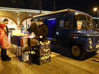 A person prepares sausages traditionally served at blue Nyska van in Krakow, Poland on December 18, 2024. (