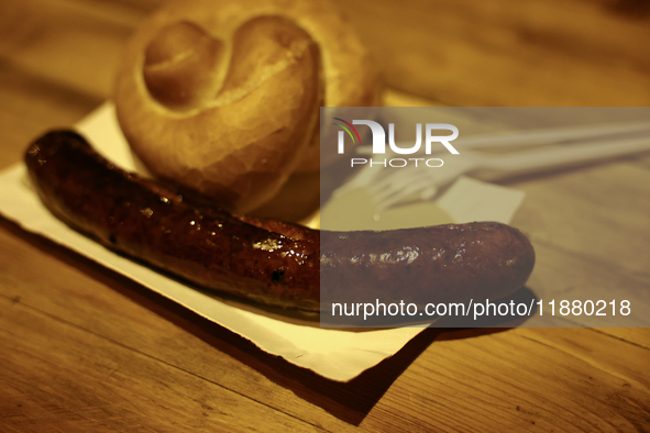 A sausage with a roll and moustard is seen in this illustartion photo taken while traditionally served at blue Nyska van in Krakow, Poland o...