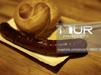 A sausage with a roll and moustard is seen in this illustartion photo taken while traditionally served at blue Nyska van in Krakow, Poland o...