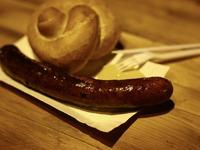 A sausage with a roll and moustard is seen in this illustartion photo taken while traditionally served at blue Nyska van in Krakow, Poland o...