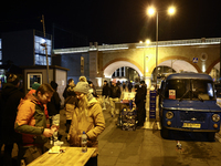 A person prepares sausages traditionally served at blue Nyska van in Krakow, Poland on December 18, 2024. (