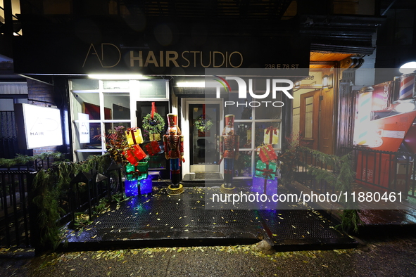 Christmas lights and decorations adorn the exterior of a hair studio on the Upper East Side in New York, N.Y., on December 16, 2024. 