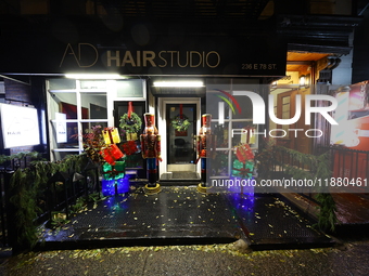 Christmas lights and decorations adorn the exterior of a hair studio on the Upper East Side in New York, N.Y., on December 16, 2024. (