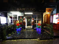 Christmas lights and decorations adorn the exterior of a hair studio on the Upper East Side in New York, N.Y., on December 16, 2024. (