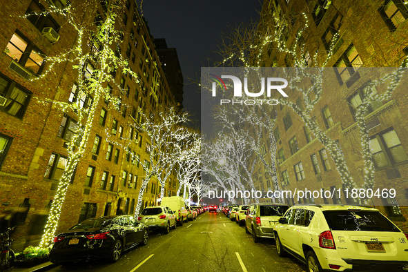 Christmas lights cover trees on a street in the Upper East Side section of New York, N.Y., on December 15, 2024. 