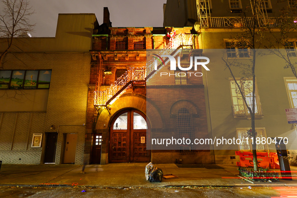 Christmas lights and Santa Claus decorate the stairs outside of an old carriage house in the Upper East Side section of New York, N.Y., on D...