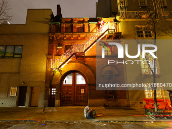 Christmas lights and Santa Claus decorate the stairs outside of an old carriage house in the Upper East Side section of New York, N.Y., on D...