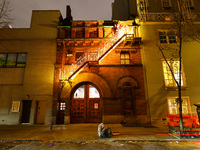 Christmas lights and Santa Claus decorate the stairs outside of an old carriage house in the Upper East Side section of New York, N.Y., on D...