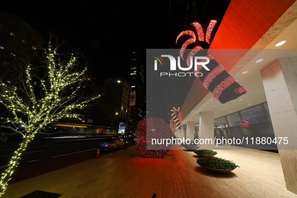 Giant candy canes hang outside an office building on W. 57th Street in New York, N.Y., on December 12, 2024. 