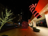 Giant candy canes hang outside an office building on W. 57th Street in New York, N.Y., on December 12, 2024. (