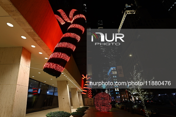 Giant candy canes hang outside an office building on W. 57th Street in New York, N.Y., on December 12, 2024. 