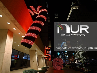 Giant candy canes hang outside an office building on W. 57th Street in New York, N.Y., on December 12, 2024. (