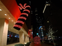 Giant candy canes hang outside an office building on W. 57th Street in New York, N.Y., on December 12, 2024. (