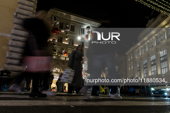 Italian shoppers browse Christmas gifts in central Rome, Italy, on December 18, 2024. Consumer activity in the run-up to Christmas is key to...