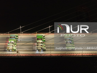 Vehicles perform a static load test on the Baguazhou Yangtze River Bridge in Nanjing, China, on December 18, 2024. (