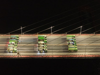 Vehicles perform a static load test on the Baguazhou Yangtze River Bridge in Nanjing, China, on December 18, 2024. (