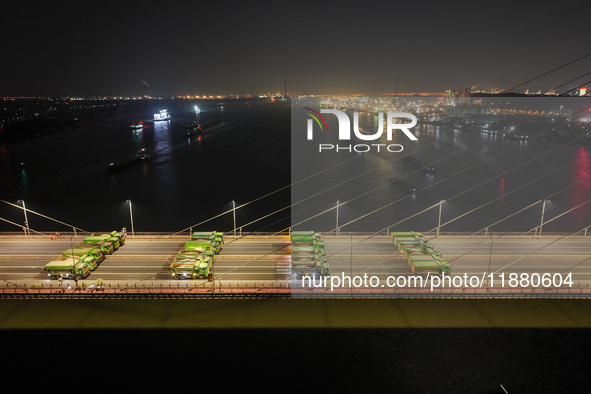 Vehicles perform a static load test on the Baguazhou Yangtze River Bridge in Nanjing, China, on December 18, 2024. 