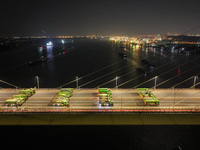 Vehicles perform a static load test on the Baguazhou Yangtze River Bridge in Nanjing, China, on December 18, 2024. (