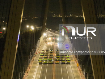 Vehicles perform a static load test on the Baguazhou Yangtze River Bridge in Nanjing, China, on December 18, 2024. (