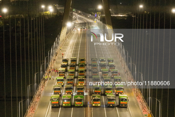 Vehicles perform a static load test on the Baguazhou Yangtze River Bridge in Nanjing, China, on December 18, 2024. 