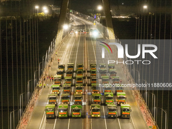 Vehicles perform a static load test on the Baguazhou Yangtze River Bridge in Nanjing, China, on December 18, 2024. (