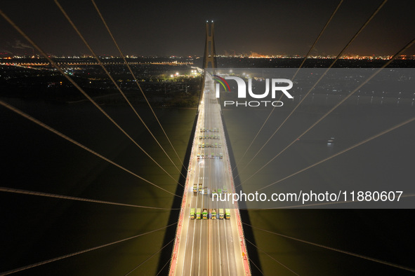 Vehicles perform a static load test on the Baguazhou Yangtze River Bridge in Nanjing, China, on December 18, 2024. 