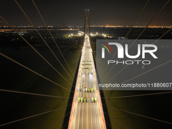 Vehicles perform a static load test on the Baguazhou Yangtze River Bridge in Nanjing, China, on December 18, 2024. (