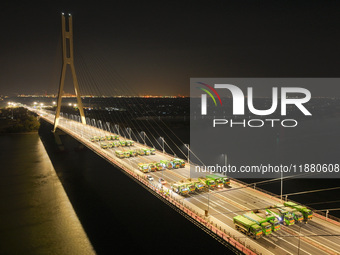 Vehicles perform a static load test on the Baguazhou Yangtze River Bridge in Nanjing, China, on December 18, 2024. (