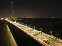 Vehicles perform a static load test on the Baguazhou Yangtze River Bridge in Nanjing, China, on December 18, 2024. (