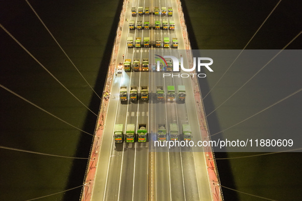 Vehicles perform a static load test on the Baguazhou Yangtze River Bridge in Nanjing, China, on December 18, 2024. 