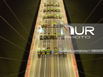 Vehicles perform a static load test on the Baguazhou Yangtze River Bridge in Nanjing, China, on December 18, 2024. (