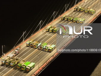 Vehicles perform a static load test on the Baguazhou Yangtze River Bridge in Nanjing, China, on December 18, 2024. (