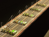 Vehicles perform a static load test on the Baguazhou Yangtze River Bridge in Nanjing, China, on December 18, 2024. (