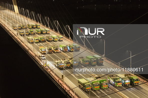 Vehicles perform a static load test on the Baguazhou Yangtze River Bridge in Nanjing, China, on December 18, 2024. 