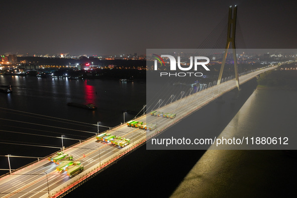 Vehicles perform a static load test on the Baguazhou Yangtze River Bridge in Nanjing, China, on December 18, 2024. 