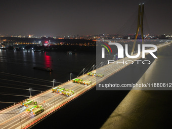 Vehicles perform a static load test on the Baguazhou Yangtze River Bridge in Nanjing, China, on December 18, 2024. (