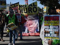 Mexican migrants who have been deported from the United States to Mexico, families seeking asylum, and activists demonstrate for migrants' r...