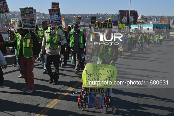 Mexican migrants who have been deported from the United States to Mexico, families seeking asylum, and activists demonstrate for migrants' r...