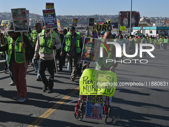 Mexican migrants who have been deported from the United States to Mexico, families seeking asylum, and activists demonstrate for migrants' r...