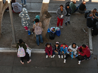 Migrants wait for their CBP One asylum appointments and observe from the Chaparral PedWest border as Mexican migrants who have been deported...