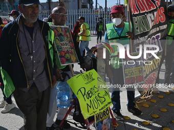 Mexican migrants who have been deported from the United States to Mexico, families seeking asylum, and activists demonstrate for migrants' r...