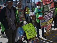 Mexican migrants who have been deported from the United States to Mexico, families seeking asylum, and activists demonstrate for migrants' r...