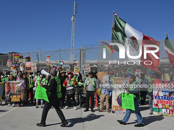 Mexican migrants who have been deported from the United States to Mexico, families seeking asylum, and activists demonstrate for migrants' r...