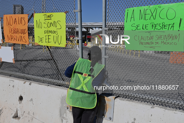 A migrant seeking asylum looks into the United States as migrants like her and activists demonstrate for migrants' rights, the arrival of Pr...