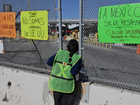 A migrant seeking asylum looks into the United States as migrants like her and activists demonstrate for migrants' rights, the arrival of Pr...