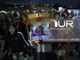 Residents of the town of Culhuacan in Mexico City, on December 18, 2024,  walk on a vehicular bridge while participating in a posada on Chri...