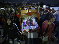 Residents of the town of Culhuacan in Mexico City, on December 18, 2024,  walk on a vehicular bridge while participating in a posada on Chri...